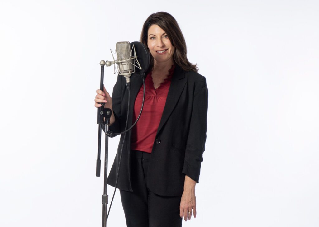 A voice over coach holding a microphone