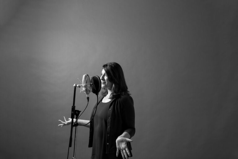 An online voice acting coach speaking into a mic